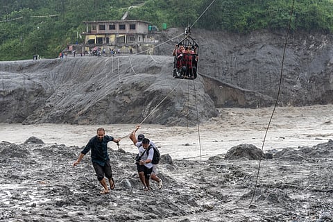 Residents pull a newly installed zipline to help people commute across the Trishuli river in the aftermath of flash floods at Bidur in Nepal’s Nuwakot district, Nepal, Wednesday, Sept. 2, 2026. 
