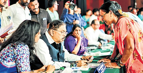 DCM Dr G Parameshwara attends to the grievances of the public at the launch of the Praja Seva campaign at Gubbi in Tumakuru district on Saturday.