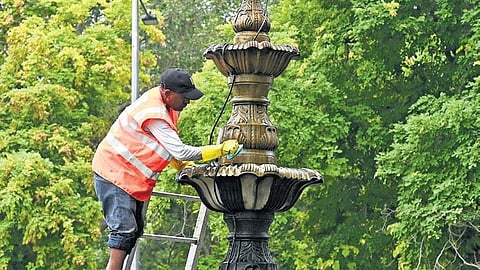 An NDMC worker cleans a fountain at India Gate Circle.