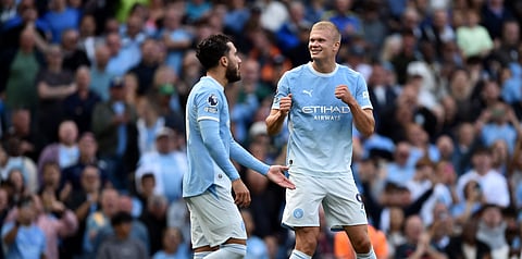Man City's Erling Haaland (R) rejoices after scoring against Coventry