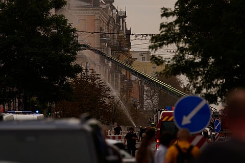Firefighters work to extinguish a fire after a Russian drone attack struck a building in downtown Kyiv, Ukraine, Friday, Sept. 4, 2026. 
