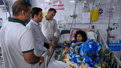 Relatives visit Kiana Karimi, 14, who was wounded during a strike what Iranian media said was a U.S. strike late Tuesday, in Kuhestak, as she lies on the bed in a hospital in town of Minab in southern Iran, Saturday, September 5, 2026.
