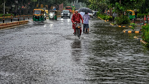  A cyclist wades through a waterlogged Baba Kharak Singh road following heavy rainfall, in New Delhi, Saturday, Sept. 5, 2026. 