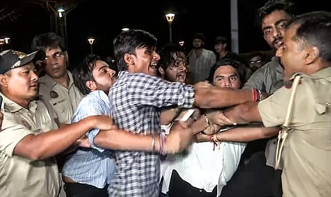 Delhi Police detain Akhil Bharatiya Vidyarthi Parishad members protesting at the MCD Office at Civic Centre over the Satya Niketan building collapse incident, in New Delhi on Sunday.