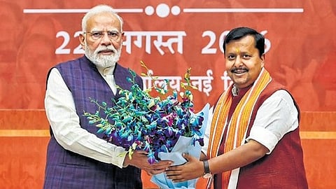 Prime Minister Narendra Modi being greeted by BJP president Nitin Nabin.