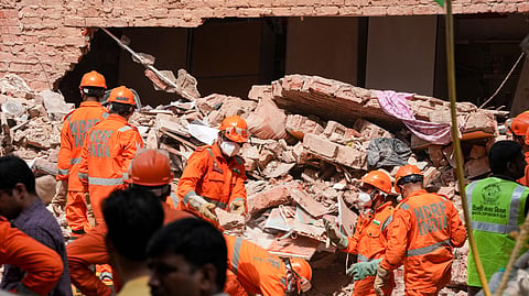 National Disaster Response Force (NDRF) personnel clear rubble during rescue operations following the collapse of a multi-storey building housing a PG, at Satya Niketan, in New Delhi, Monday, Sept. 7, 2026.