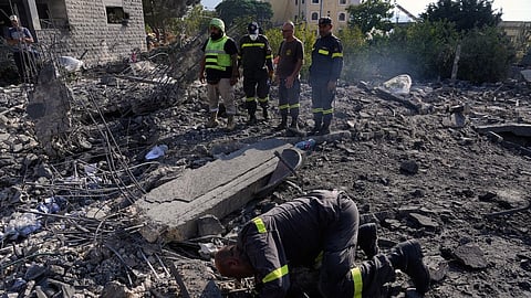 Rescue workers search for victims under the rubble of a building destroyed in an Israeli airstrike in the southern village of Kfar Rumman, Lebanon, Monday, Sept. 7, 2026.