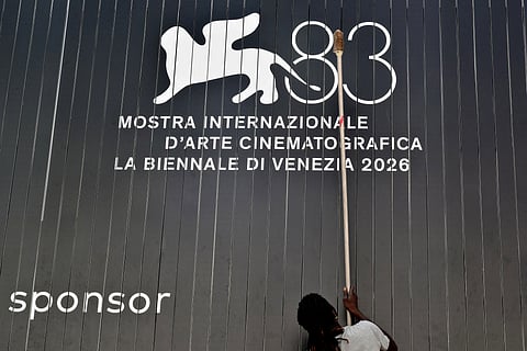  A man cleans an advertising board displaying the logo of the 83Rd Venice Film Festival, at Venice Lido on September 1, 2026. 