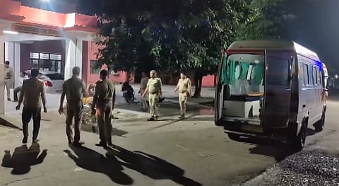 Police personnel stand near an ambulance as a bus with passengers from Rajasthan to Budaun overturned after hitting a road divider, in Baghpat district, Uttar Pradesh, Monday, Sept. 7, 2026. 