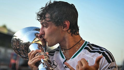 Mercedes' Italian driver Kimi Antonelli kisses the trophy after winning the Italian Formula One Grand Prix at the Autodromo Nazionale Monza circuit in Monza, northern Italy on September 6, 2026.