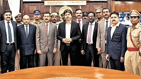 CM Vijay with police, fire and rescue service department officials on Monday.