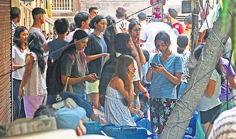 Students vacate the PG accomodation beside the collapsed building 