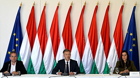 Hungarian Prime Minister Péter Magyar, centre, attends the first, out-of-town cabinet meeting of the new Tisza government flanked by Balint Ruff, Head of the Prime Minister's Office, and Foreign Minister Anita Orban, right, in the Opusztaszer National Historical Memorial Park in Opusztaszer, Hungary, Wednesday, May 13, 2026. 