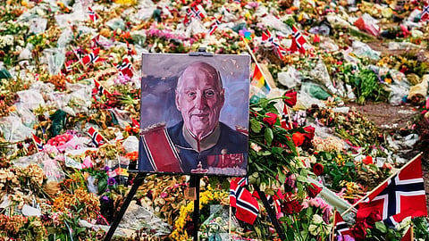 A painting of Norway's late King Harald stand in flora tributes at the Palace Square in Oslo, Norway, Monday, Sept. 7, 2026.