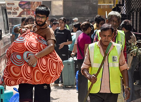  Students carry their belongings as they vacate their PGs adjacent to the Satya Niketan PG building which collapsed near Delhi University's South Campus, following a demolition order by the Municipal Corporation of Delhi (MCD), in New Delhi, Tuesday,
