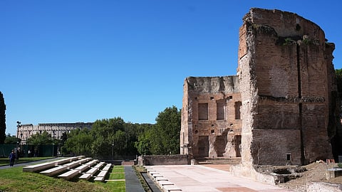 The southwestern exedra of the Baths of Trajan, backdropped by the Colosseum, sits above the underground foundations where the restored "Painted City" fresco and Great Mosaic were discovered in the 1990s, in Rome, Sept. 8, 2026.