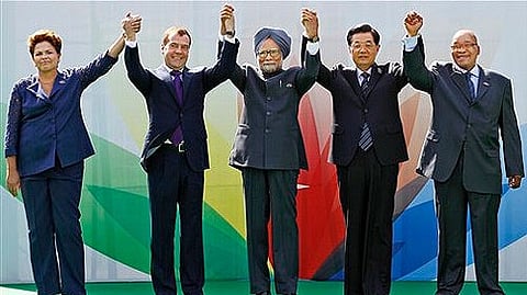 Brazil's President Dilma Rousseff, Russian President Dmitry Medvedev, Indian Prime Minister Manmohan Singh, Chinese President Hu Jintao, and South African President Jacob Zuma raise their arms together during the BRICS 2012 Summit in New Delhi.