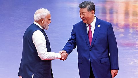 In photograph taken on August 31, 2025, Prime Minister Narendra Modi (L) and China’s President Xi Jinping shake hands during the welcome ceremony of the Shanghai Cooperation Organization (SCO) summit in Tianjin.