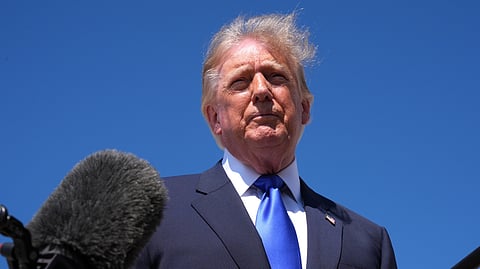 Trump speaks with reporters before traveling to Dallas for the midterm Republican convention.