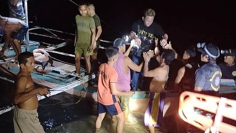 In this image provided by the Philippine Coast Guard, a survivor is assisted as he alights from a small boat after being rescued from a burning ferry off Palawan province, Philippines on Wednesday Sept. 9, 2026. 