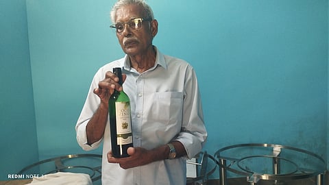 Sebastine P Augustine with his Coco Vino wine.