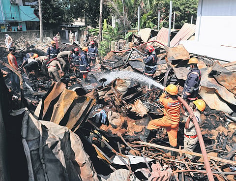 Fire and Rescue Services personnel work to douse fire that broke out in a pile of waste materials at Pattom in Thiruvananthapuram on Thursday 