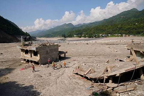 Nepal army soldiers inspect houses destroyed by recent flash floods in Betrawati, Nepal, Tuesday, Sept. 8, 2026.