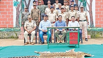 Forest team poses with the leopard hide 