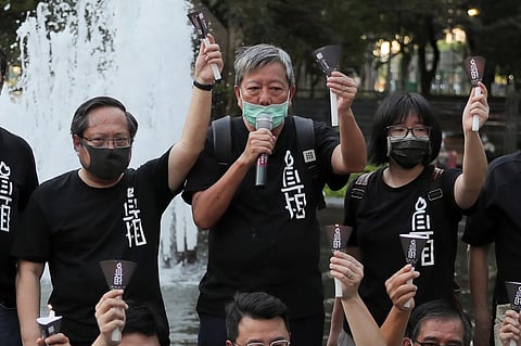 Pro-democracy activists including from left Albert Ho, Lee Cheuk-yan and Chow Hang-tung shout slogans during a gathering to mourn those killed in the 1989 Tiananmen crackdown at Victoria Park in Causeway Bay, Hong Kong on June 4, 2020. 