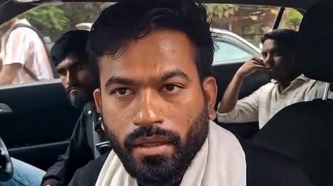 Cockroach Janta Party (CJP) founder Abhijeet Dipke talks to the media as he arrives to visit affected tribal families at a village, in Balaghat district, Madhya Pradesh, Saturday, Sept. 12, 2026.