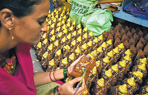 An artist gives the final touches to Ganesh idols in Vijayawada 