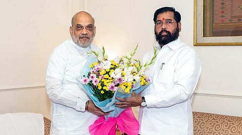 Union Home and Cooperation Minister Amit Shah being welcomed with a flower bouquet by Maharashtra Deputy Chief Minister Eknath Shinde during his two-day Mumbai visit, at Sahyadri Guest House, in Mumbai on Sunday. 