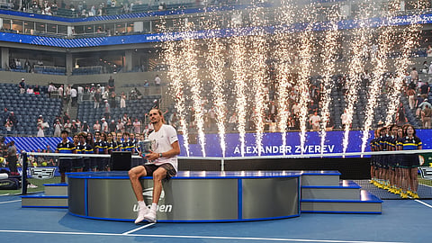 Alexander Zverev, of Germany, holds his trophy after winning the men's singles final of the US Open tennis championships against Ben Shelton, of the United States, Sunday, Sept. 13, 2026, in New York. 