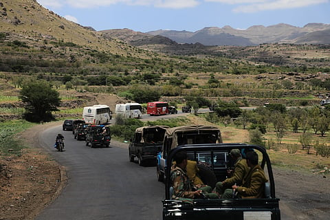 Houthi fighters escort a convoy carrying prisoners freed in Mokha through the Bani Matar district on its way to Sanaa, Yemen, Saturday, Sept. 12, 2026, following the Houthi takeover of the southern Red Sea port city.