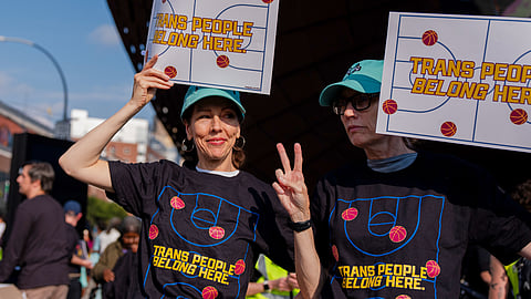 Demonstrators rally in support of transgender athletes in women's sports outside of Barclay's Center before the WNBA basketball game between the Indiana Fever and the New York Liberty, Aug. 22, 2026, in New York.