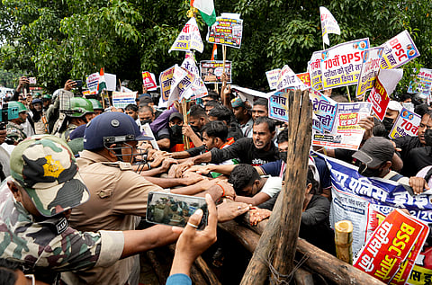 Police personnel stop candidates demanding the cancellation and re-conduct of the Bihar Police Sub-Inspector recruitment exam and the 70th BPSC Combined Competitive Examination over alleged irregularities, during a protest demonstration, in Patna, Bihar, Tuesday, Sept. 15, 2026.