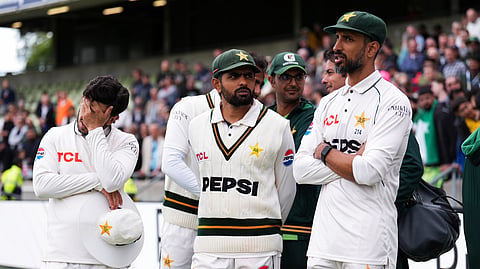 Pakistan's Babar Azam, center, with teammates following his side's defeat to England on day four of the third cricket Test at Edgbaston, in Birmingham, England, Saturday, Sept. 12, 2026.