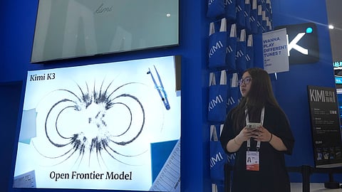 A worker stands at the booth for Chinese AI Startup Moonshot's Kimi K3 during the World AI Conference in Shanghai, China on July 17, 2026.
