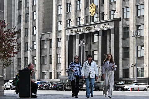 People walk along the street in front of the Russian State Duma (lower house of Russia's Parliament) in central Moscow on September 14, 2026.
The 2026 parliamentary election will be held over a three-day period from September 18 to 20.