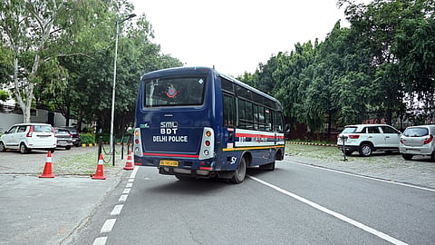 A Delhi Police vehicle present near The British School, which is among several schools across the city that received a bomb threat, in New Delhi on Tuesday.