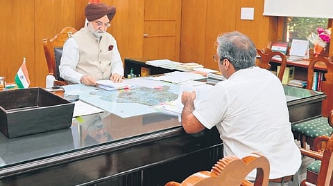 L-G Taranjit Singh Sandhu with MCD Commissioner Sanjeev Khirwar on Monday.