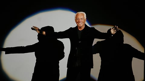 FILE - Giorgio Armani receives his share of applause after presenting his Emporio Fall-Winter 2007-2008 men's fashion collection, during the Milan Men's Fashion Week, in Milan, Italy, Monday, Jan. 15, 2007.