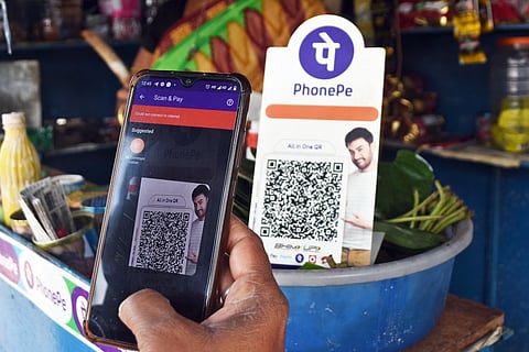 A man doing online payment at a pan shop in Bhubaneswar