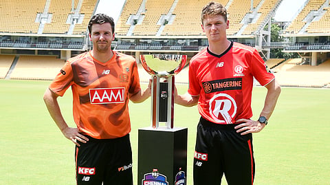 Perth Scorchers' Jhye Richardson (L) and Melbourne Renegades' Brendan Doggett pose for a photograph with the trophy after the Big Bash League (BBL) opening game presser, at the MA Chidambaram Stadium in Chennai on Thursday