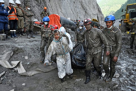 In this handout photograph provided by the Nepal Army, Nepalese soldiers carry the bodies of workers recovered during a search and rescue operation at the Chilime hydropower project following earlier flash floods in Nepal's Rasuwa district, Wednesday, Sept. 16, 2026.