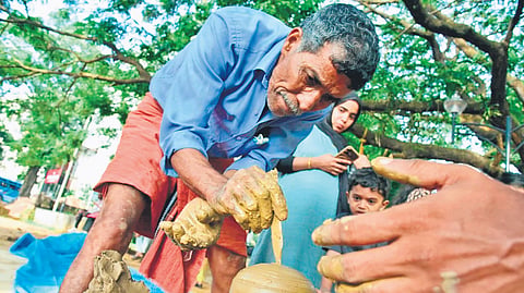 Makkuttan Balan demonstrating the process of making clay vessels