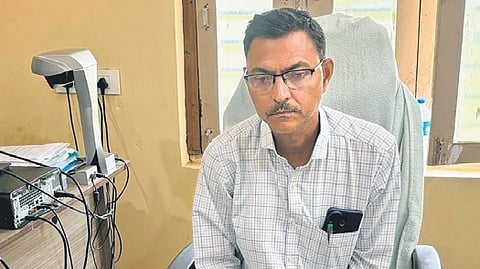 Tahsildar Nellutla Srujan Kumar with the bribe money at the MRO office in Govindaraipet mandal in Mulugu