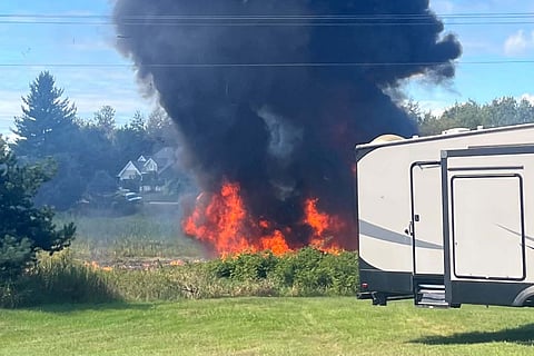 Smoke rises after an F-16 fighter jet crashed in a rural area near Traverse City, Mich., Thursday, Sept. 17, 2026. 