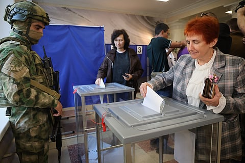 Voters cast ballots at a polling station during Russia's parliamentary election, in the Russian-controlled part of the Donetsk region, Ukraine, Friday, Sept. 18, 2026.