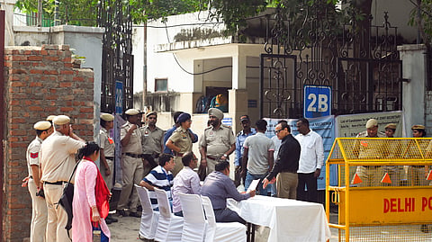  Security personnel and polling officials present outside the counting centre on the counting day of Delhi University Students’ Union (DUSU) polls, in New Delhi on Saturday.